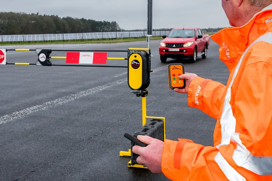 Operative in hi-vis raising a barrier with a long range handset