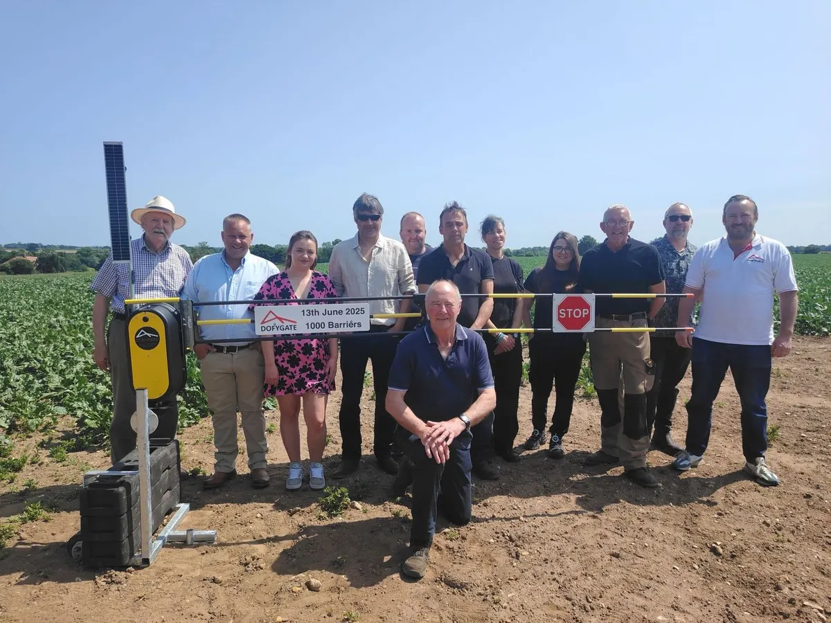 Dofygate staff, family and friends gathered round the 1,000th solar powered barrier in a Norfolk field