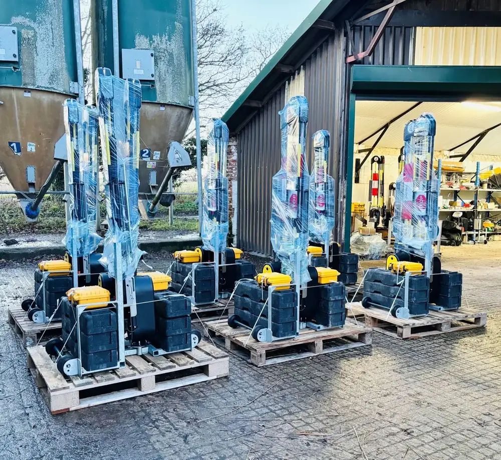 Shrink-wrapped solar powered barriers on pallets outside the Dofygate workshop