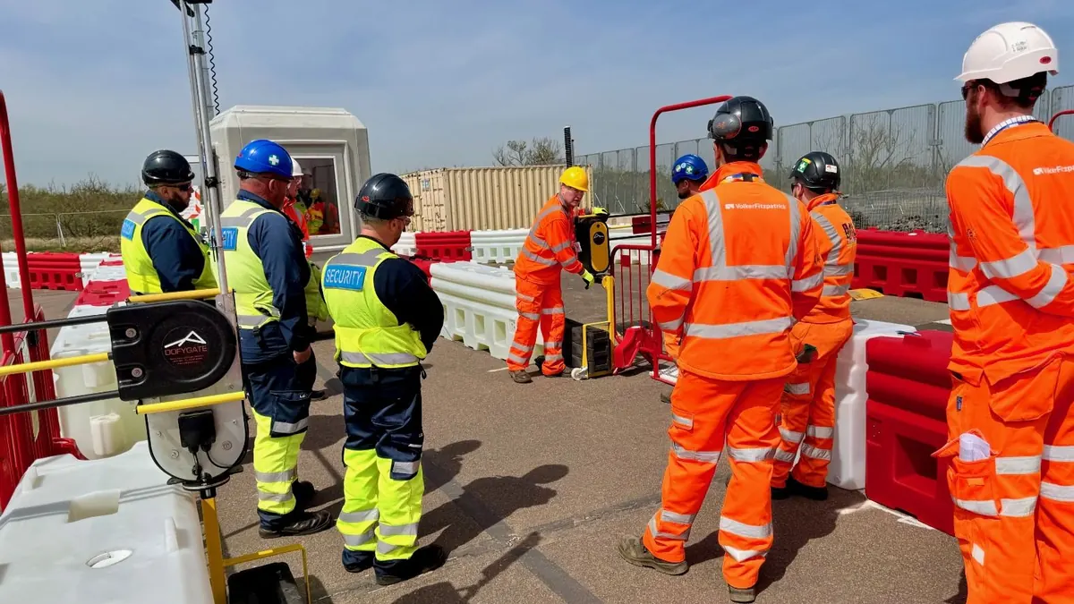 Contractors and the Dofygate team checking automatic traffic barriers on an infrastructure site