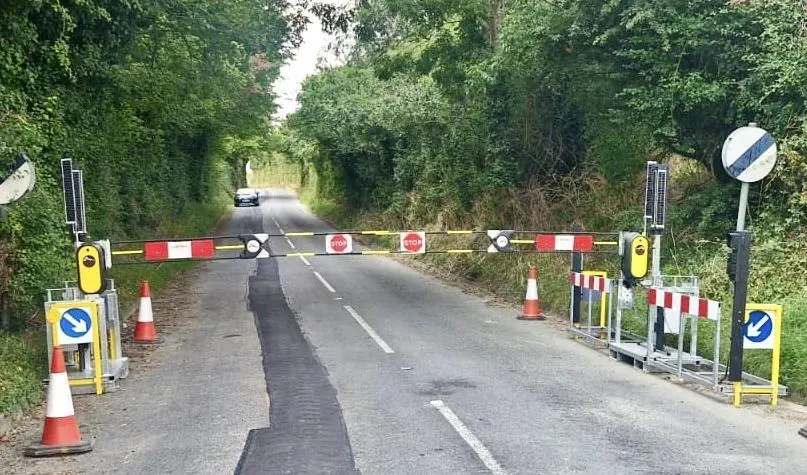 Winged ComboPallets holding two automatic traffic barriers across a rural road